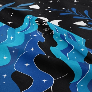 Detail of bohemian tapestry featuring a starry hair goddess and soft fabric texture