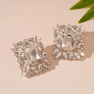 Macro shot of silver stud earrings with rectangular crystal and marquise rhinestones