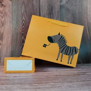 Yellow paper gift bag with cute zebra print and durable cord handles for shopping