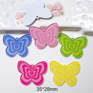 Detail showing colorful acrylic butterfly charms with glitter measuring 35x28mm for DIY crafts