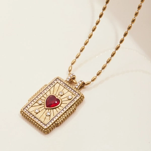 Gold stainless steel necklace featuring a rectangular pendant with a red heart gem