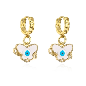 Detail of gold-plated butterfly earrings with white enamel and blue evil eye charms