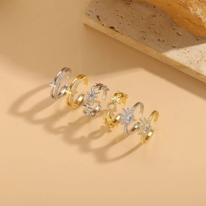 Detailed view of geometric zircon open rings in gold and silver plating on stone decor