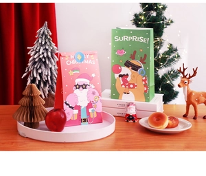 Detailed view of Christmas gift bags featuring Santa and Reindeer on a wooden table