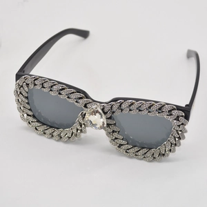 Fashionable cat eye sunglasses with diamond chain accents and a large crystal drop detail