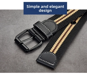 Detail of striped canvas belt with black matte buckle and leather trim on stone surface