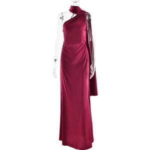 Detail of wine red satin evening gown featuring a stylish one-shoulder cut and cape design