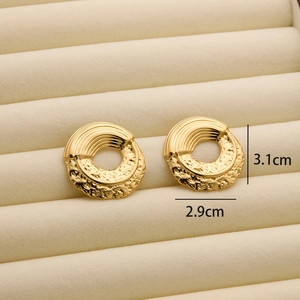 Close-up of 18K gold plated hoop earrings with brushed stripe and rock texture details