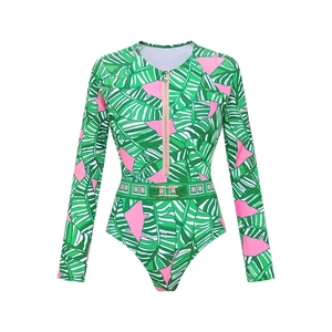 Detail of tropical leaf print long sleeve surf swimsuit with front zipper and gold buckle
