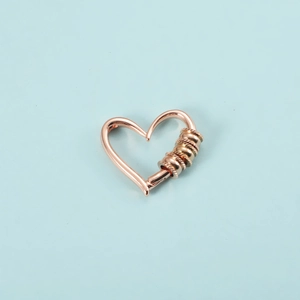 Detailed view of a hollow heart-shaped bead charm in rose gold finish with spiral texture