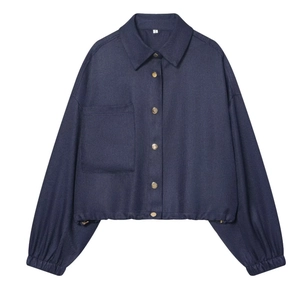 Détail de la veste courte bleu marine avec boutons métalliques et grande poche poitrine