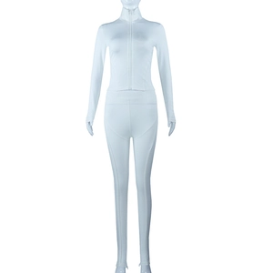 Detail of white two-piece yoga set featuring full zipper stand collar and elastic fabric