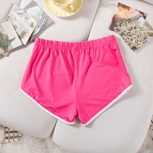 Macro detail of rose pink sports shorts with white elastic waist and retro piping