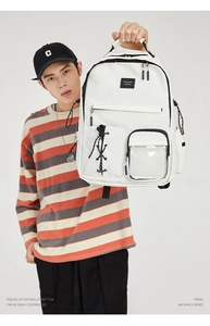 Detailed view of white large capacity backpack with clear front pocket and YILETAO brand tag