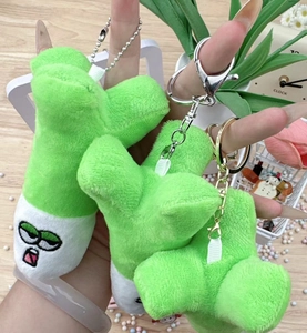 Detailed view of plush green pea shooter keychain with metallic clasp and soft texture