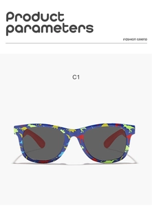 Macro detail of blue kids sunglasses featuring vibrant cartoon dinosaur prints and grey lenses