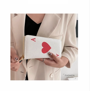 Detailed view of women's long canvas wallet featuring red heart ace card design