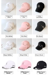 Detailed view of baseball caps collection with metal chains, pins and ring charms