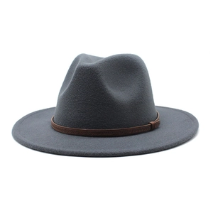 Detail of dark grey wool fedora hat featuring a brown leather band with braided texture
