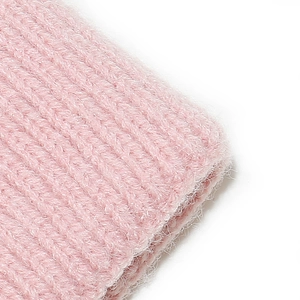 Close-up of pink knit winter hat featuring soft long-hair fleece and ribbed texture