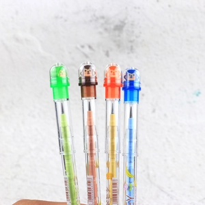 Close-up of four colorful cartoon monkey pencils with transparent plastic bodies