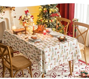 Close-up of snowman and Christmas tree patterns on festive cotton linen tablecloth