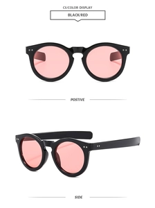 Detail view of round retro sunglasses featuring black frames and vibrant red lenses