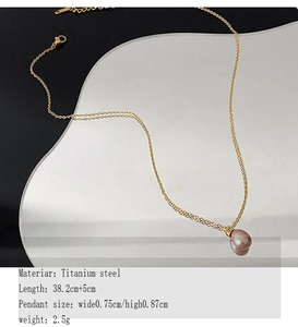 Detailed macro view of a single lavender pearl pendant on a gold titanium steel chain