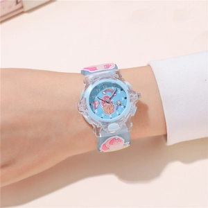 Close-up of light blue kids watch with unicorn patterns and soft silicone strap
