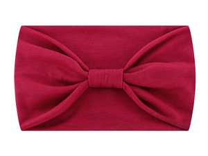 Close-up of red knotted fabric headband showing detailed texture and soft material