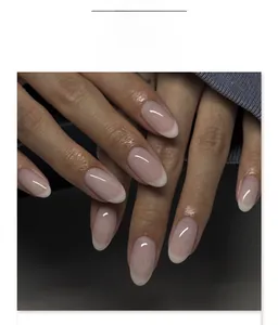 Detail of short round French ombre press-on nails in soft pink and white gradient