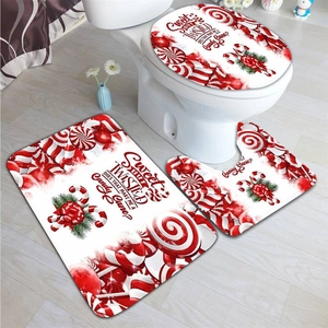 Three-piece bathroom mat set with candy cane theme including rug and toilet lid cover