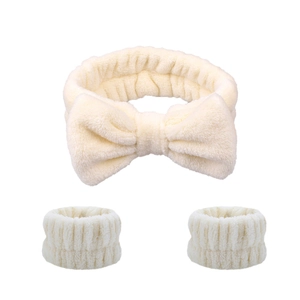 Three-piece cream plush set with bow headband and soft wristbands for skincare