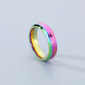 Detail of rainbow titanium ring with hammered texture and polished colorful finish