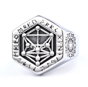 Macro shot of silver Viking ring with Tree of Life symbol and Rune carvings