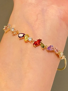 Detail of 18k gold plated bracelet with colorful zircon stones worn on wrist