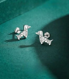Macro view of origami dachshund stud earrings made of polished S925 sterling silver