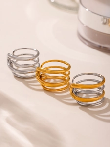 Macro shot of minimalist multi-layer spiral titanium steel rings in gold and silver