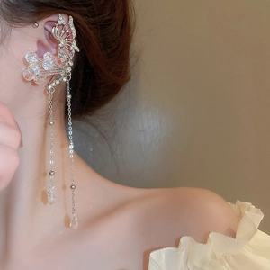 Detailed view of silver butterfly ear cuff with crystal tassels on a model
