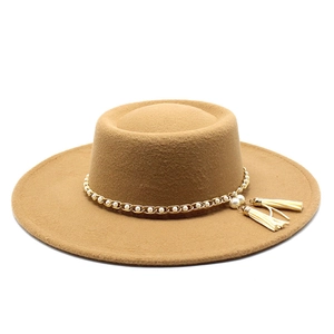 Detail of camel wool boater hat featuring a pearl gold chain and double tassel accents