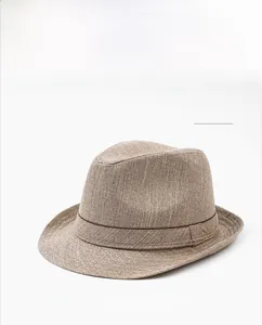 Detailed top view of a khaki linen fedora hat featuring a fine woven texture and decorative band
