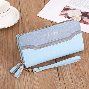 Detail of grey and blue dual-layer leather wallet with gold zippers and wrist strap