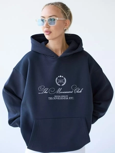 Detail of navy blue hoodie featuring The Movement Club letter print and drawstring hood