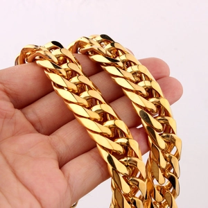Close-up of a thick gold-plated stainless steel Cuban link chain with glossy finish