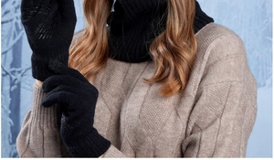 Close-up of black ribbed knit scarf and touchscreen gloves for winter warmth protection