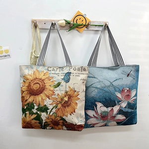 Floral jacquard tote bags with sunflower and lotus prints featuring striped woven handles