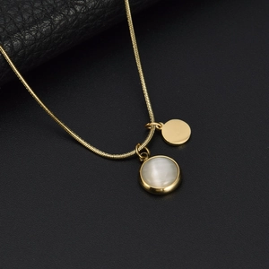 Elegant gold snake chain necklace featuring a white cat eye stone and gold disc pendant
