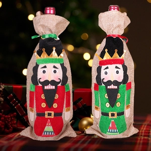 Detail of red and green nutcracker wine bottle bags made of rustic linen with drawstring