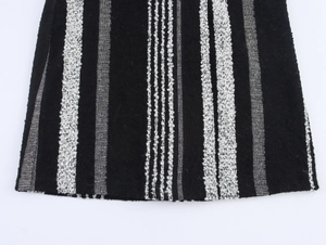 Close-up of black and white vertical striped wool coat with thick knit fabric texture