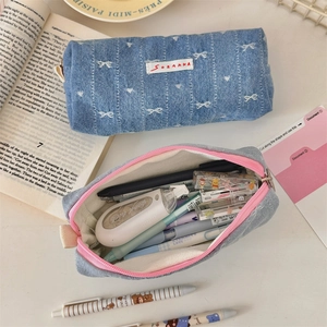 Detailed view of large capacity denim pencil cases with bow embroidery and zipper closure